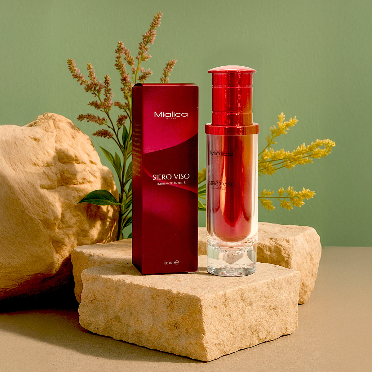 Siero Viso Mialica con scatola su pietre e sfondo verde